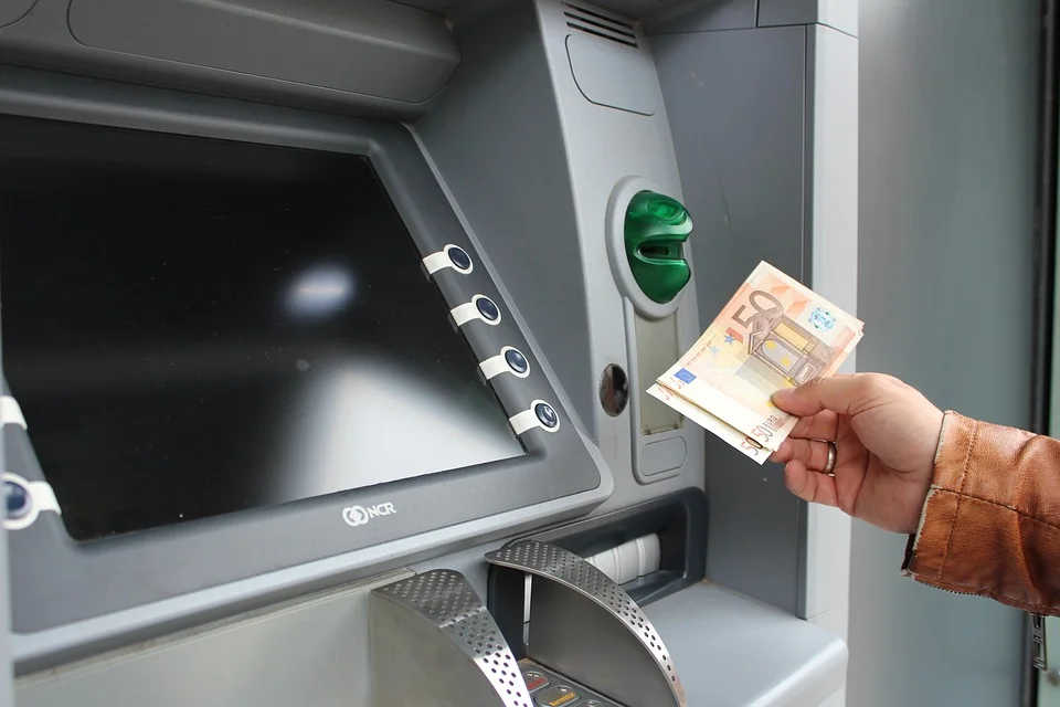 Výběr bankovek z bankomatu – ilustrační fotografie.