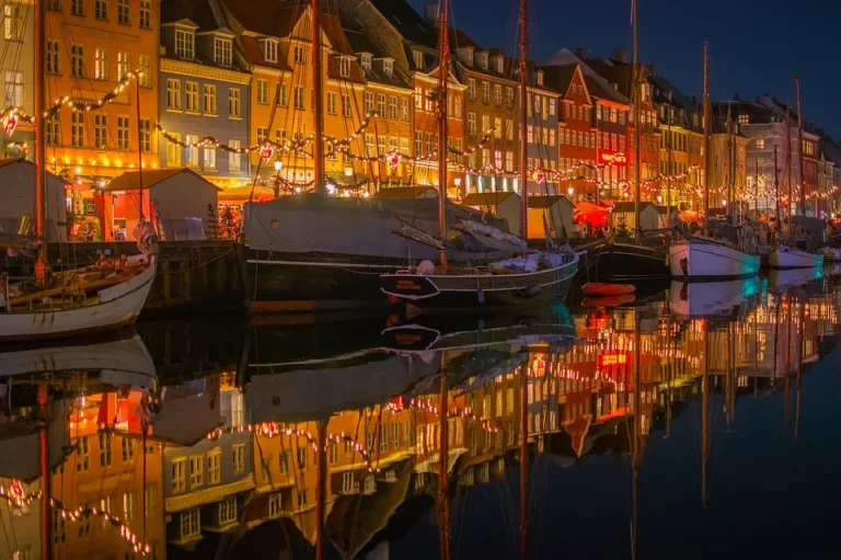 Barevné domy a lodě u osvětleného kodaňského nábřeží Nyhavn